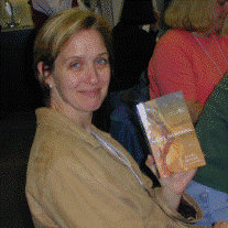Laura displays the cover art for her newest release, Night Swimming, at the Chicago-North conference in April 2002